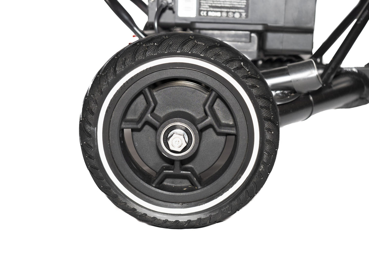 Durable rear wheel of SNAPnGO folding mobility scooter with tread for smooth rides