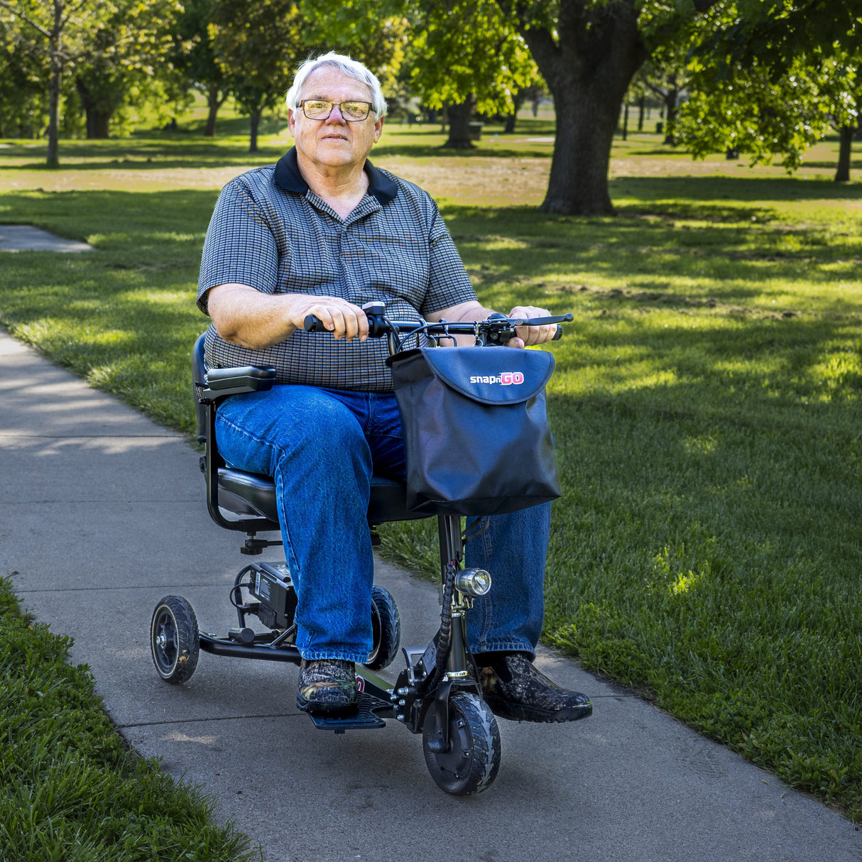 Adult man riding the SNAPnGO mobility scooter – showcasing comfort and smooth movement